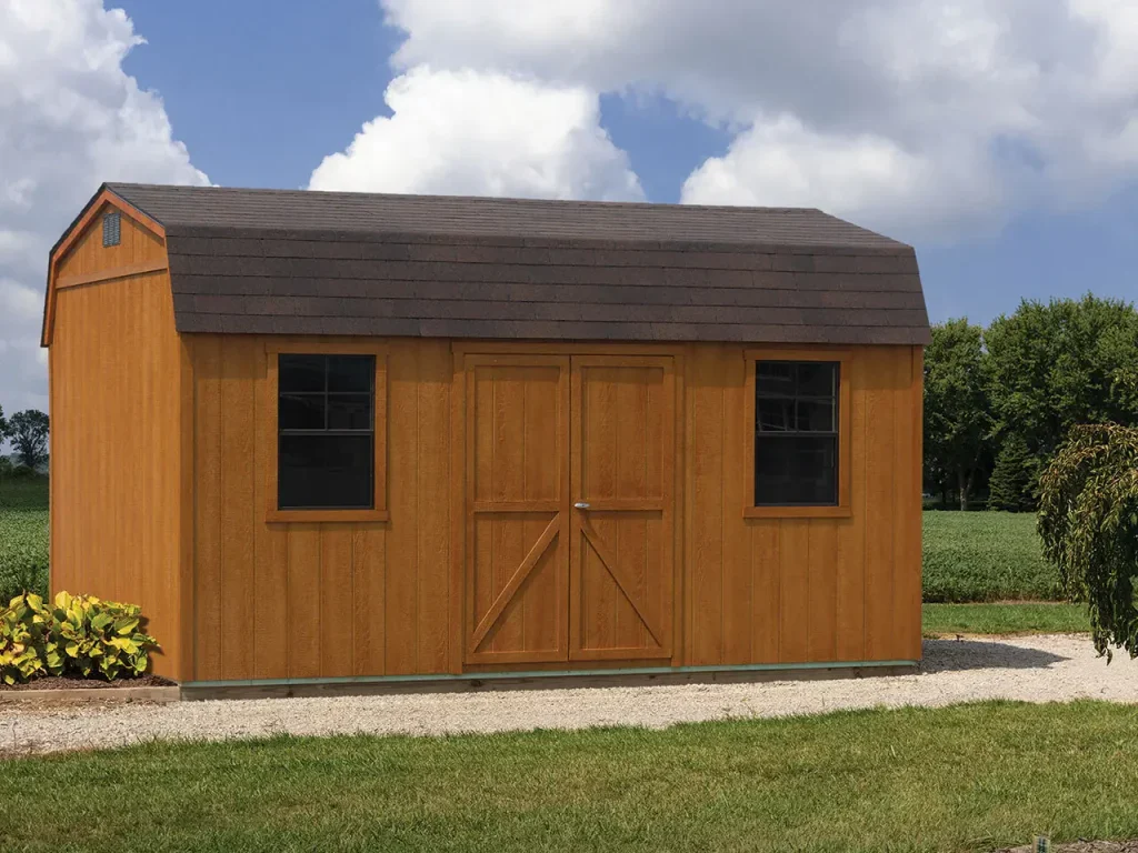 Wood tone barn style storage shed with a gambrel roof and double doors