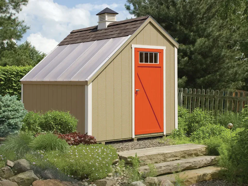 Tan lean-to style shed with a single slope metal roof and an orange door